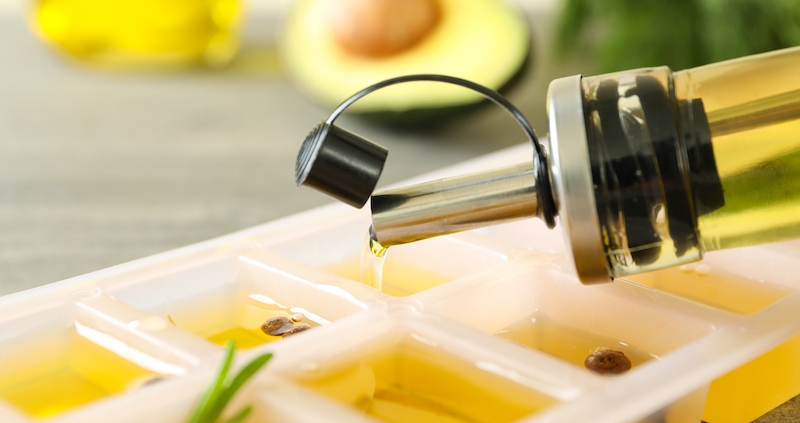 Olive oil pouring into container from stainless steel pour spout preventing Oxidation Of Olive Oil