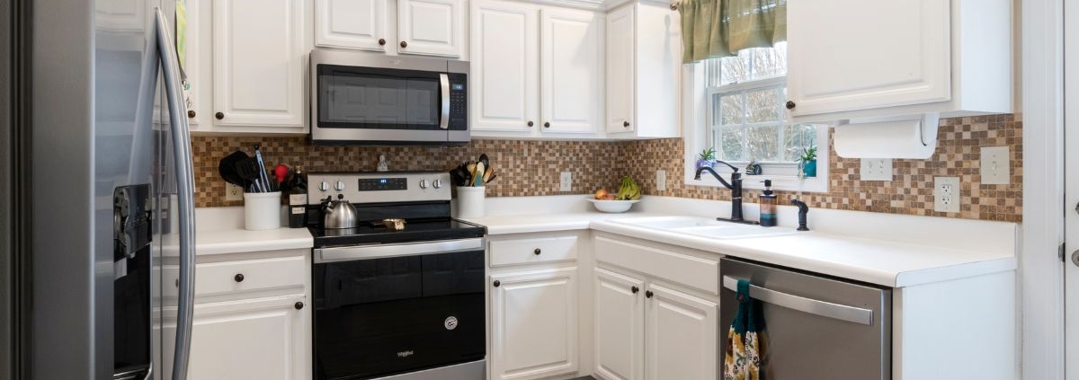 kitchen with white cabinets and light wood counters - Anytime Olive Oil Products olive oil pour spouts