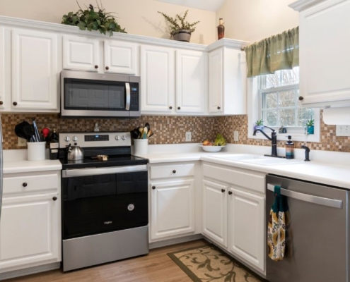 kitchen with white cabinets and light wood counters - Anytime Olive Oil Products olive oil pour spouts