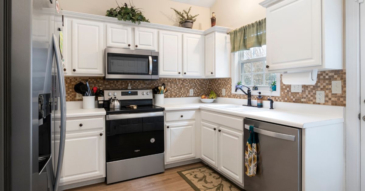 kitchen with white cabinets and stainless steel appliances - Anytime Olive Oil Products olive oil pour spouts