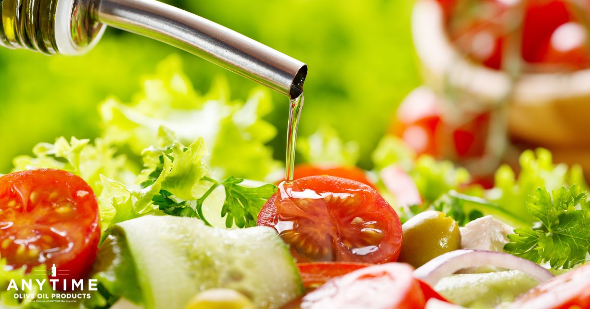 person pouring oil over tomatoes and lettuce - Anytime Olive Oil Products olive oil pour spouts