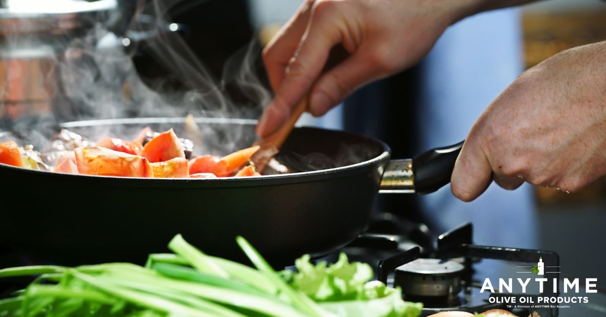 person stirring food in a fry pan - Anytime Olive Oil Products oil spout