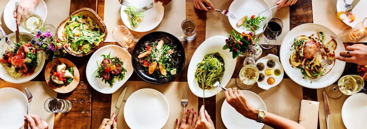aerial view of a full dinner table at a restaurant - Olive Oil Pour Spouts Anytime Bar Supplies wholesale olive oil pour spouts