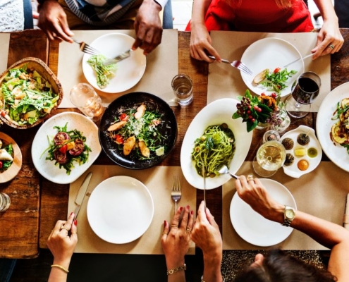 aerial view of a full dinner table at a restaurant - Olive Oil Pour Spouts Anytime Bar Supplies wholesale olive oil pour spouts