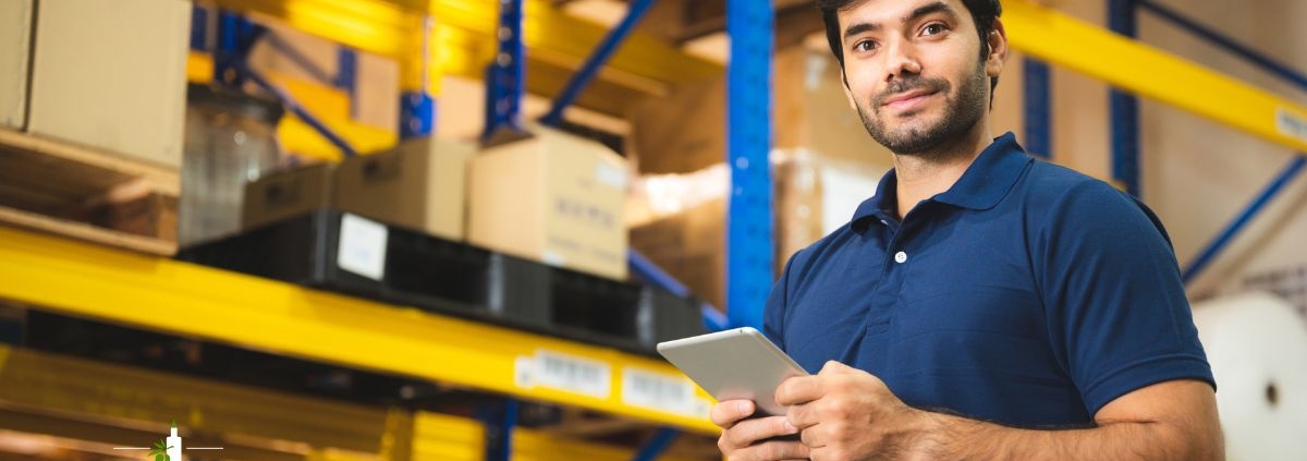 man wearing a blue shirt working in a wholesale facility - Olive Oil Pour Spouts wholesale olive oil pour spouts