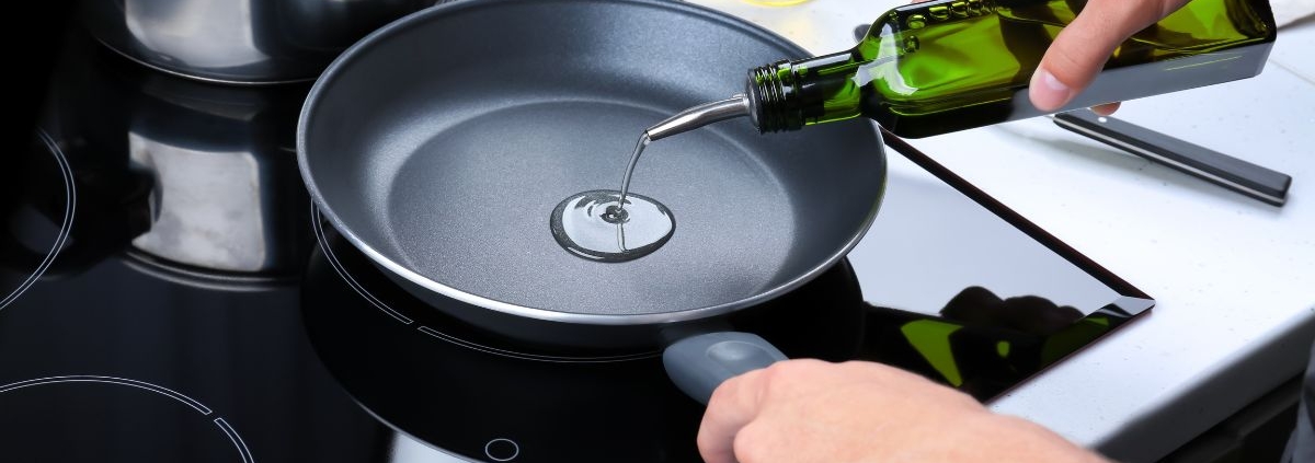 person pouring oil into a fry pan - Olive Oil Pour Spouts Commercial-Grade Olive Oil Spouts