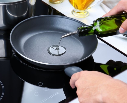 person pouring oil into a fry pan - Olive Oil Pour Spouts stainless steel oil pourer