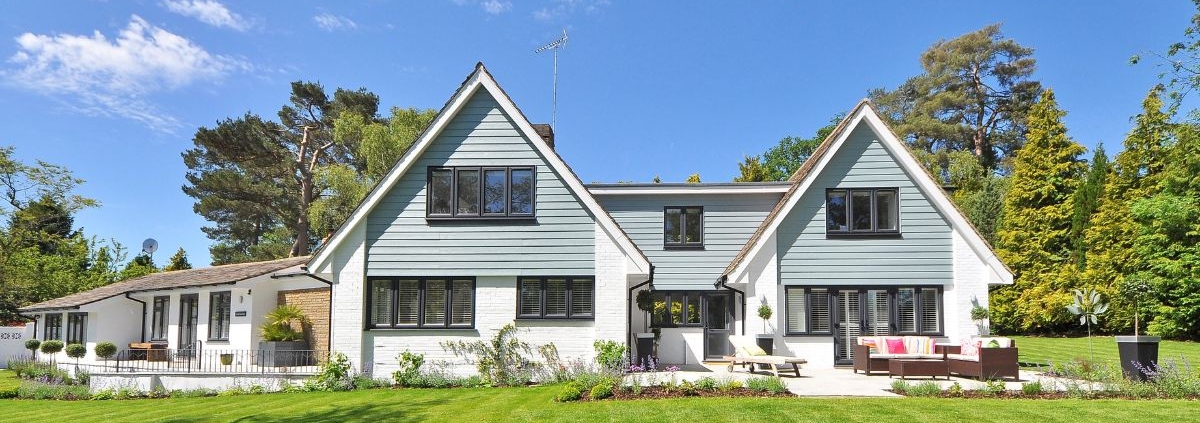 exterior of a suburban home with white brick - Anytime Olive Oil Products oil pour spout