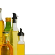 OliveOilPourSpouts-wholesale-olive-oil-pour-spout-061320252 row of oil bottles lined up together - Anytime Olive Oil Products pour spout types