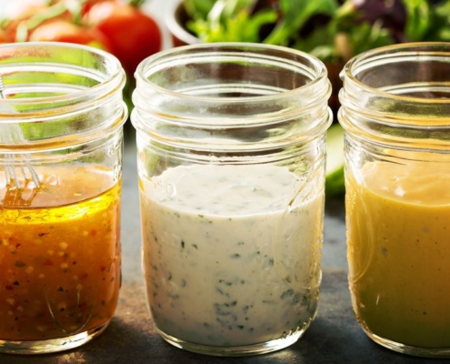 clear glass jars containing homemade salad dressing - Olive Oil Pour Spouts