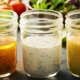 clear glass jars containing homemade salad dressing - Olive Oil Pour Spouts