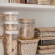 interior of a kitchen pantry with containers of dry goods - Olive Oil Pour Spouts kitchen organization reset