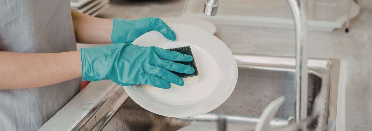 person washing dishes with a sponge - Olive Oil Pour Spouts Commercial-Grade Olive Oil Spouts