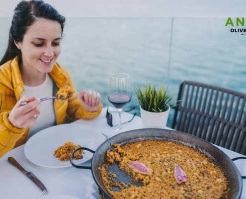 tourist woman eating a rice dish - Anytime Olive Oil Products wholesale olive oil pour spouts