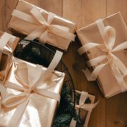 Wrapped wedding gifts on a wood table - Olive Oil Pour Spouts DIY gourmet wedding favors